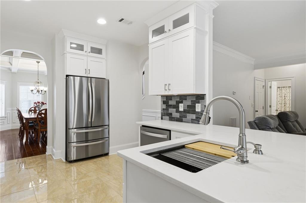 515 Sunset Street Canton, GA 30114 - Photo 18 of 64 a kitchen with stainless steel appliances kitchen island a white stove top oven and sink