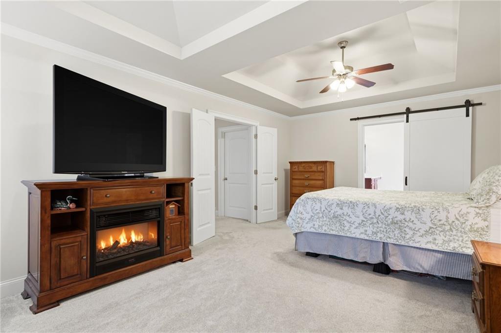 515 Sunset Street Canton, GA 30114 - Photo 21 of 64 a bedroom with a bed and a flat screen tv