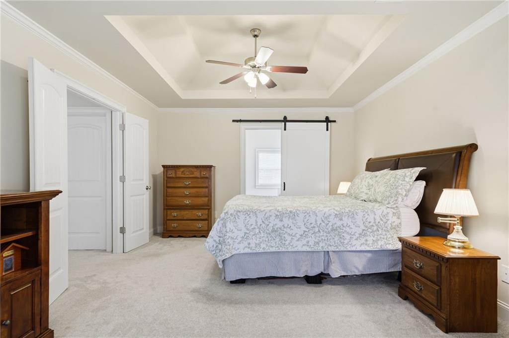 515 Sunset Street Canton, GA 30114 - Photo 22 of 64 a bedroom with a bed and a chandelier