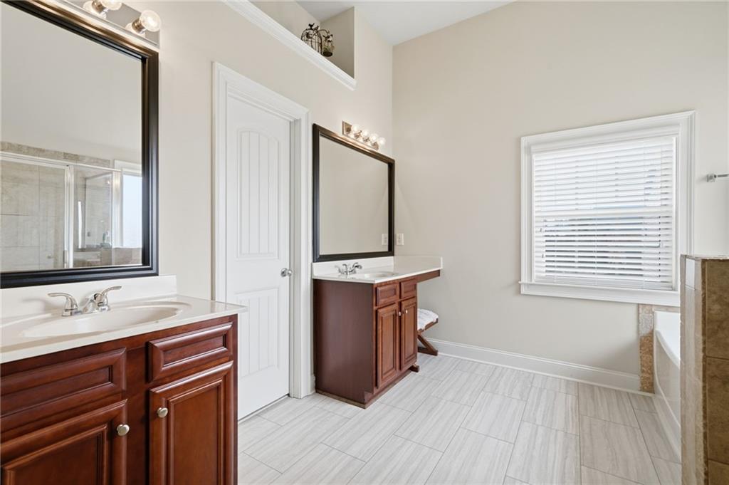 515 Sunset Street Canton, GA 30114 - Photo 25 of 64 a bathroom with a sink a vanity and a mirror