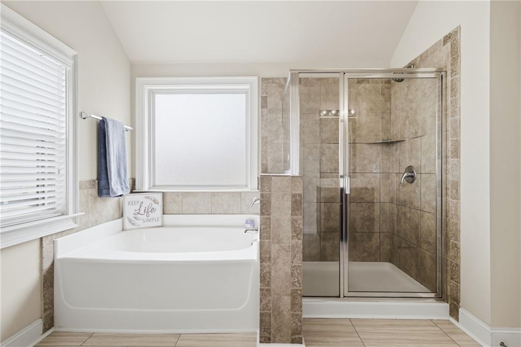 515 Sunset Street Canton, GA 30114 - Photo 26 of 64 a bathroom with a bathtub and a shower