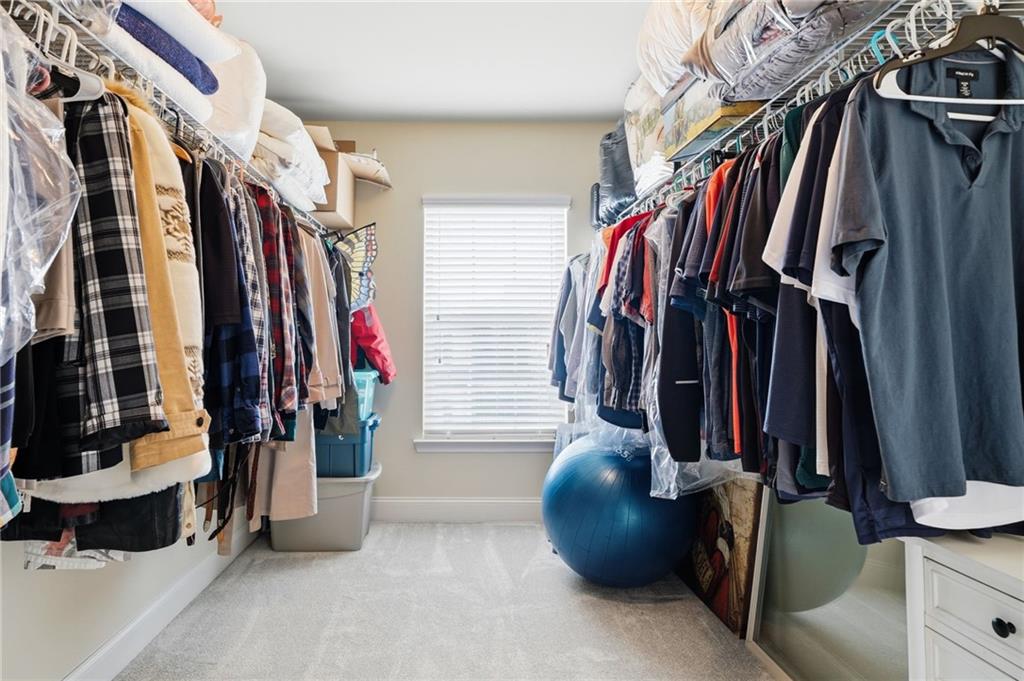 515 Sunset Street Canton, GA 30114 - Photo 27 of 64 a view of walk in closet with clothes and shoes