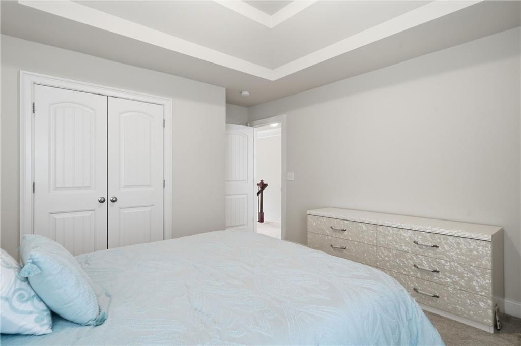 515 Sunset Street Canton, GA 30114 - Photo 32 of 64 a bedroom with a bed and white wall