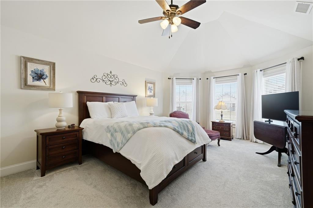 515 Sunset Street Canton, GA 30114 - Photo 33 of 64 a spacious bedroom with a bed and chair