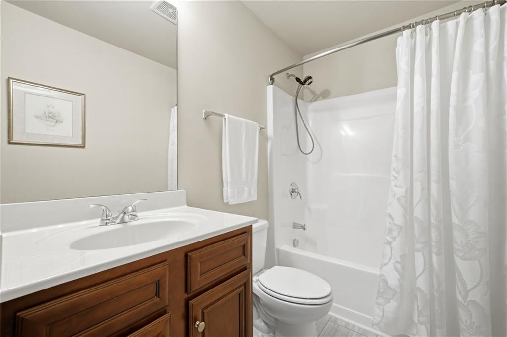 515 Sunset Street Canton, GA 30114 - Photo 35 of 64 a bathroom with a sink a toilet and a mirror