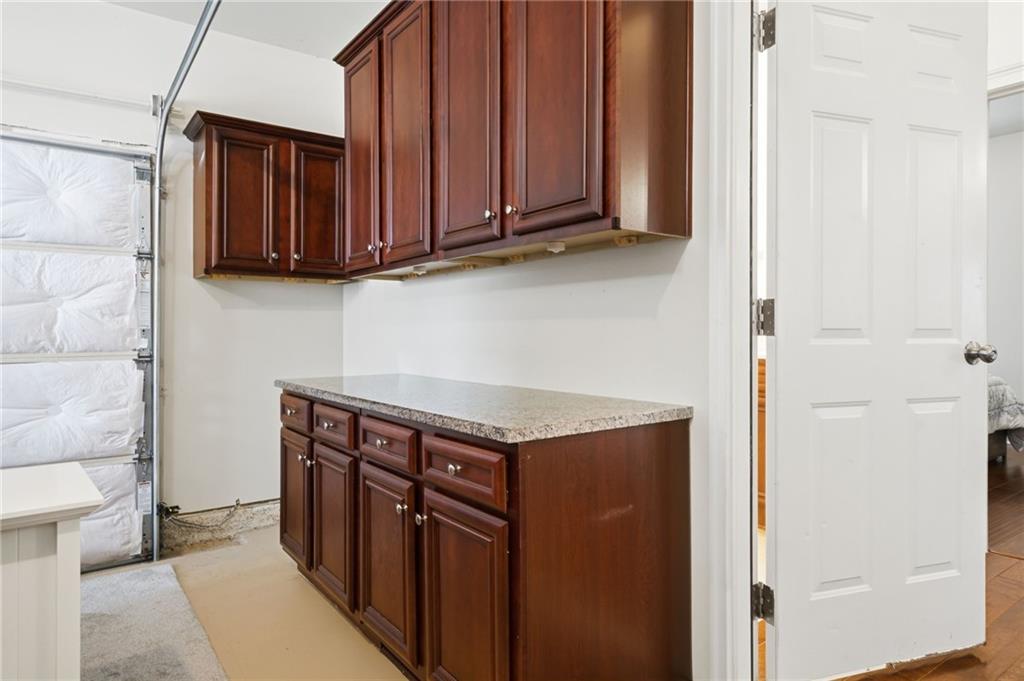 515 Sunset Street Canton, GA 30114 - Photo 42 of 64 a view of a kitchen with stainless steel appliances granite countertop wooden cabinets and a stove