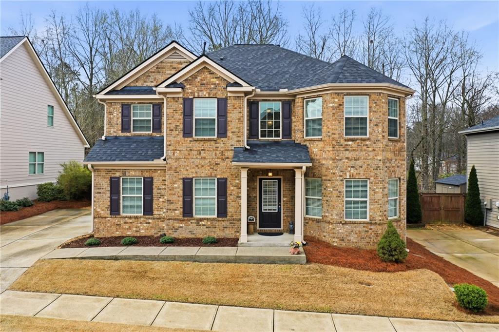 515 Sunset Street Canton, GA 30114 - Photo 52 of 64 a front view of a house with yard and tress