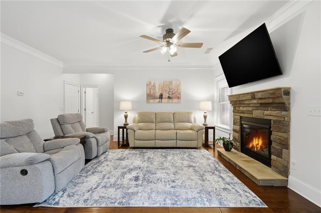 515 Sunset Street Canton, GA 30114 - Photo 8 of 64 a living room with a fireplace furniture and a flat screen tv