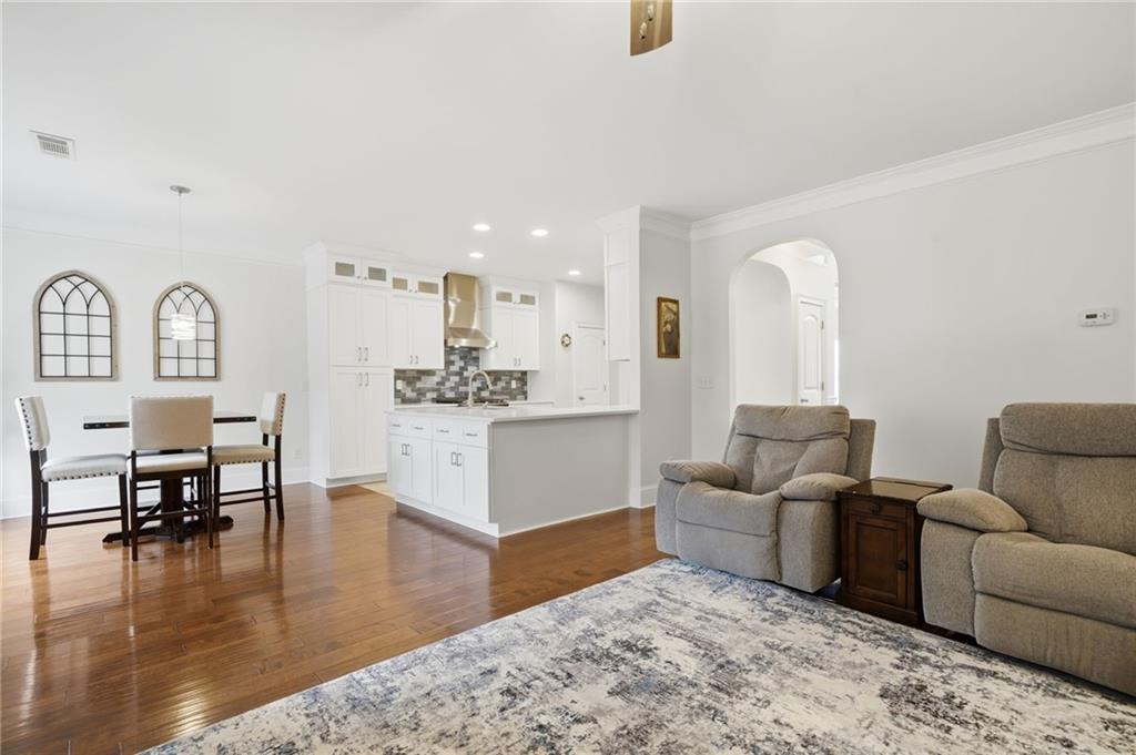 515 Sunset Street Canton, GA 30114 - Photo 10 of 64 a living room with furniture and a dining table with wooden floor