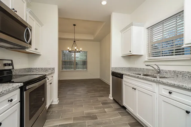 a kitchen with stainless steel appliances granite countertop a stove and a sink