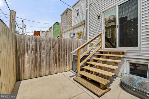 a view of a balcony with wooden floor and stairs