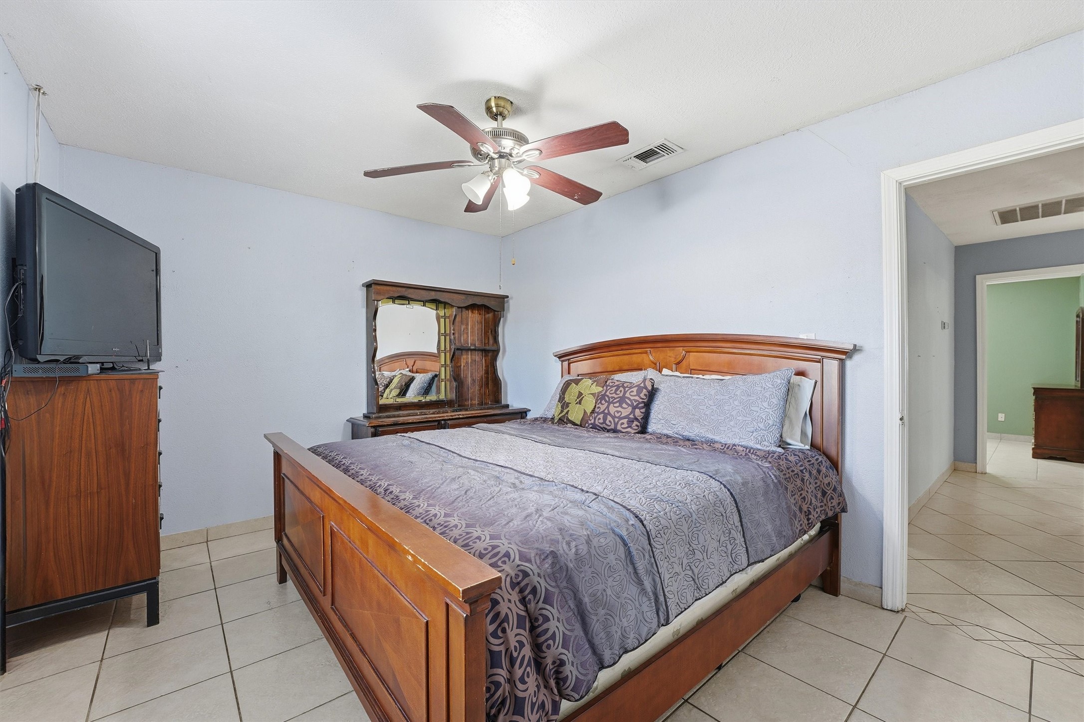 134 Obion Road Houston, TX 77076 - Photo 11 of 14 a bedroom with a bed and a flat screen tv