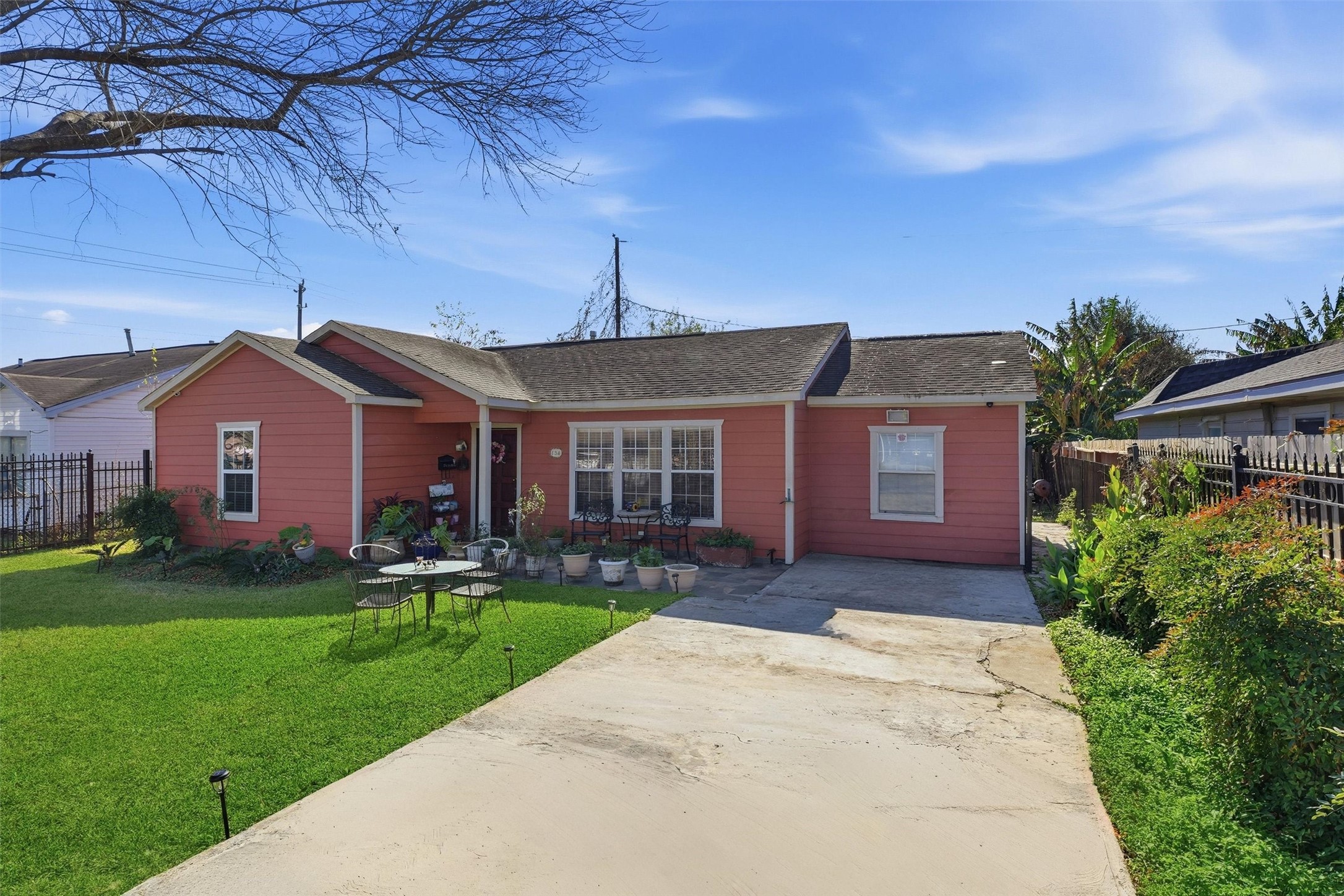 134 Obion Road Houston, TX 77076 - Photo 2 of 14 a front view of a house with a garden and yard