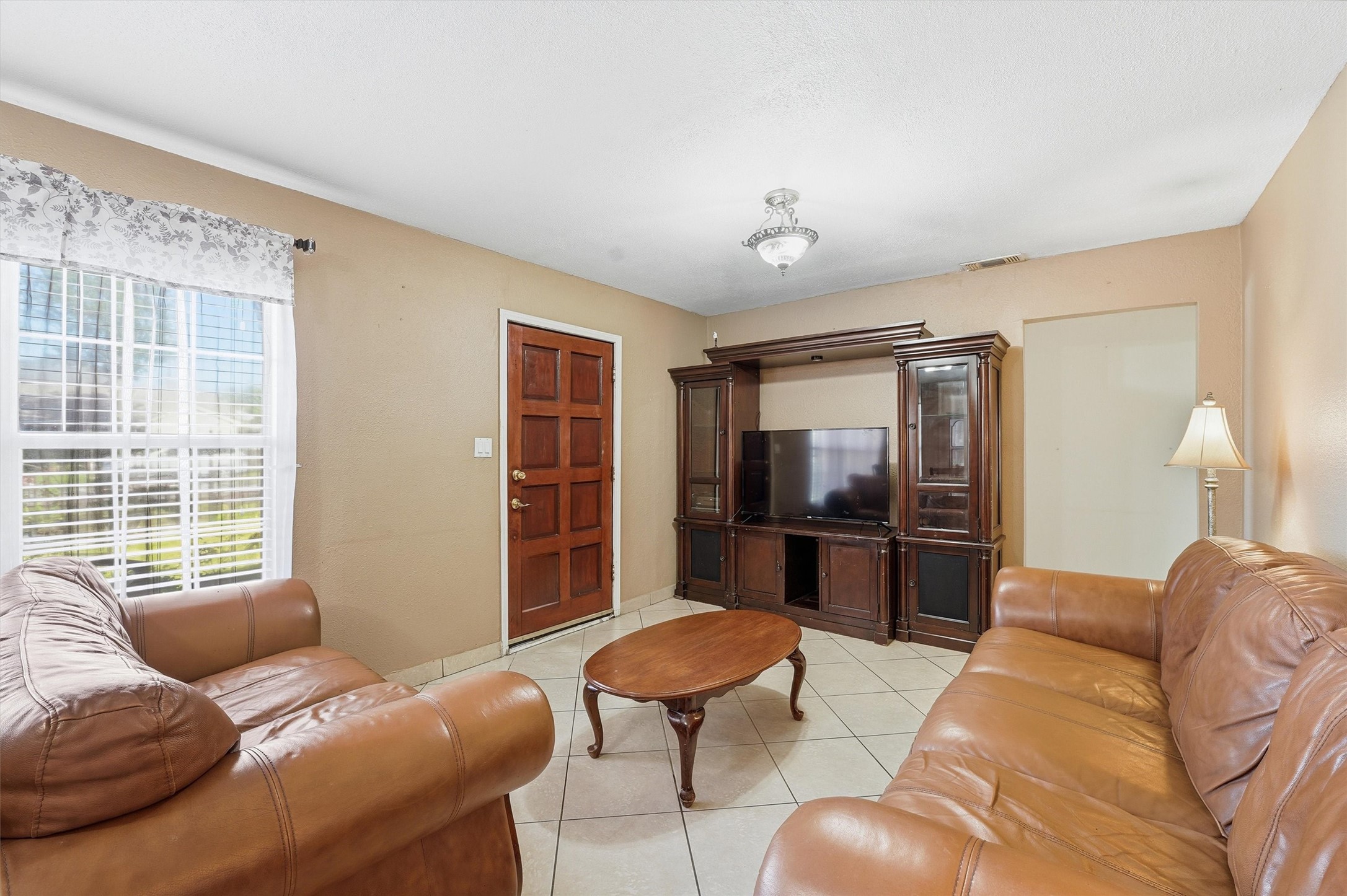 134 Obion Road Houston, TX 77076 - Photo 4 of 14 a living room with furniture and a large window