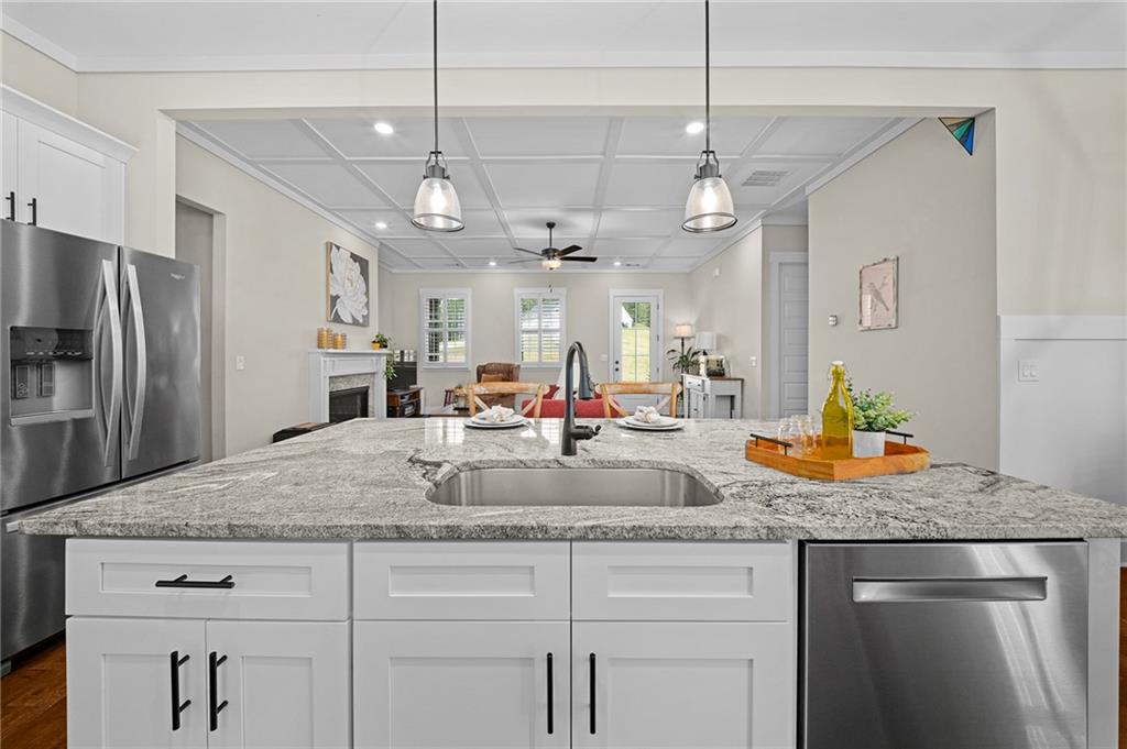 392 London Road Ball Ground, GA 30107 - Photo 12 of 53 a kitchen with stainless steel appliances granite countertop a sink a refrigerator center island and stainless steel appliances