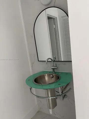 a room with a mirror and vanity