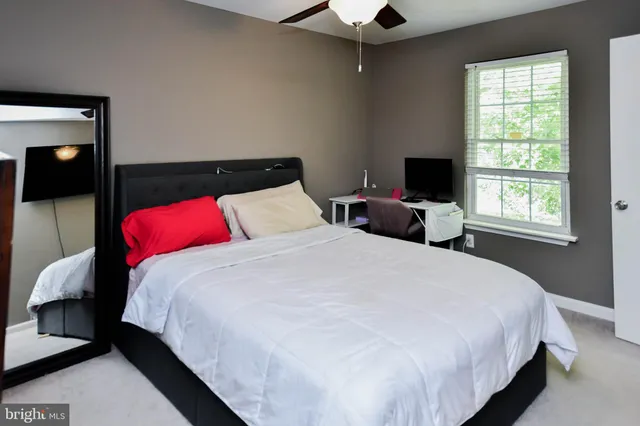 a bedroom with bed and window