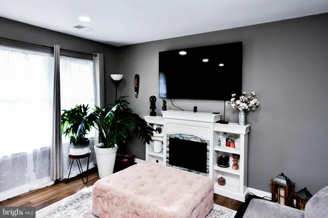 a living room with furniture a chandelier and a fireplace