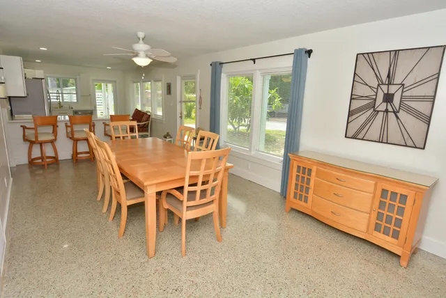 a view of a dining room with furniture and a chandelier