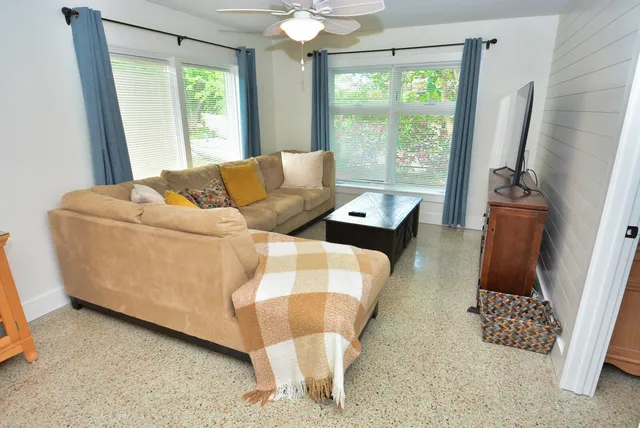 a living room with furniture and a large window
