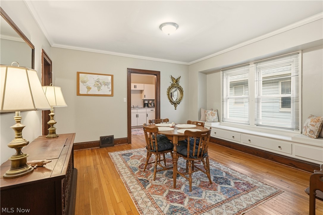 3579 Bosworth Road Cleveland, OH 44111 - Photo 10 of 39 Dining area featuring hardwood flooring, a built-in window seat with integrated storage, and a ceiling-mounted light fixture