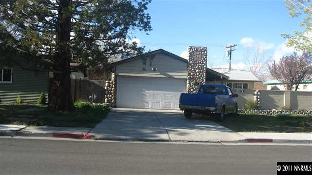 1465 Roberts Street Reno, NV 89502 - Photo 2 of 13 a front view of a house with a yard and garage