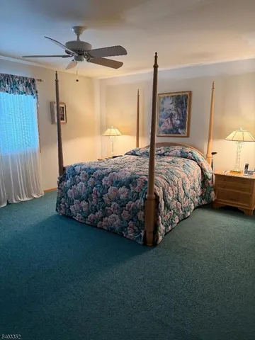 a spacious bedroom with a bed and a cabinet