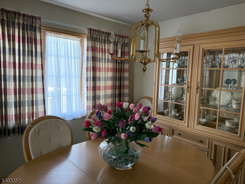 159 Wyoming Avenue Union, NJ 07083 - Photo 7 of 23 a dining room with a window and chandelier
