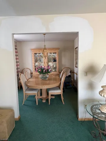 a dining room with furniture and chandelier