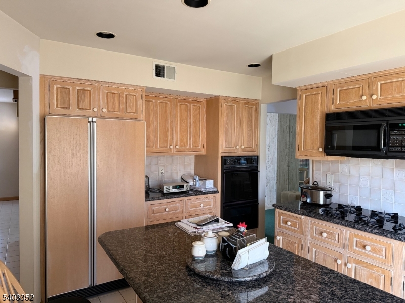 159 Wyoming Avenue Union, NJ 07083 - Photo 9 of 23 a kitchen with stainless steel appliances granite countertop a refrigerator and a stove top oven