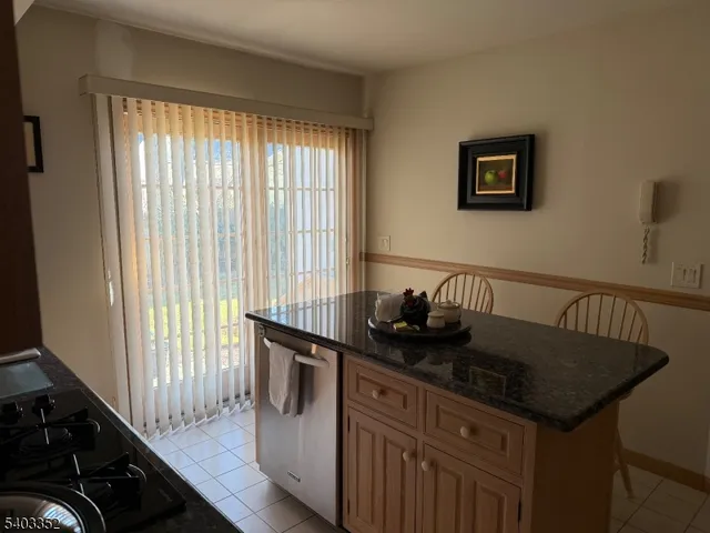 a kitchen with granite countertop a sink and a stove top oven