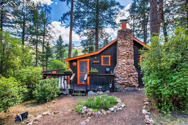 a view of a house with a yard and sitting area