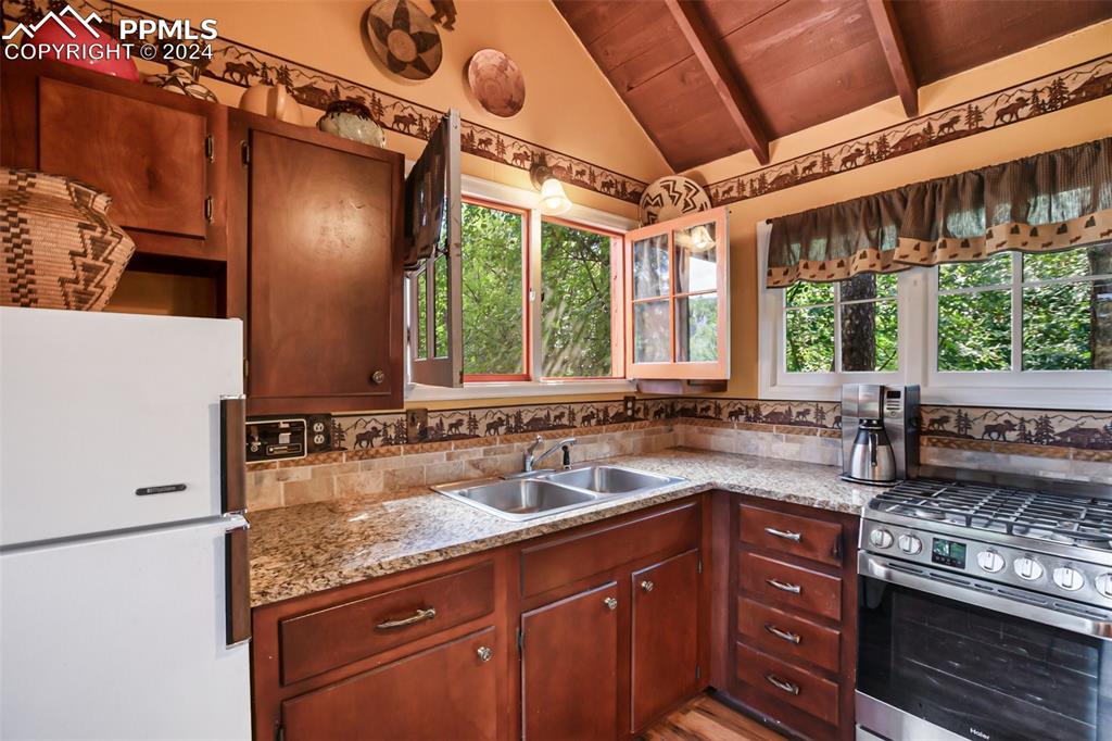 6015 Sioux Trail Cascade, CO 80809 - Photo 12 of 50 a kitchen with sink stove and cabinets