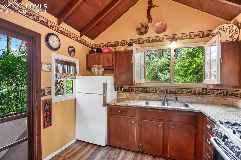 6015 Sioux Trail Cascade, CO 80809 - Photo 13 of 50 a utility room with a large window vanity and refrigerator