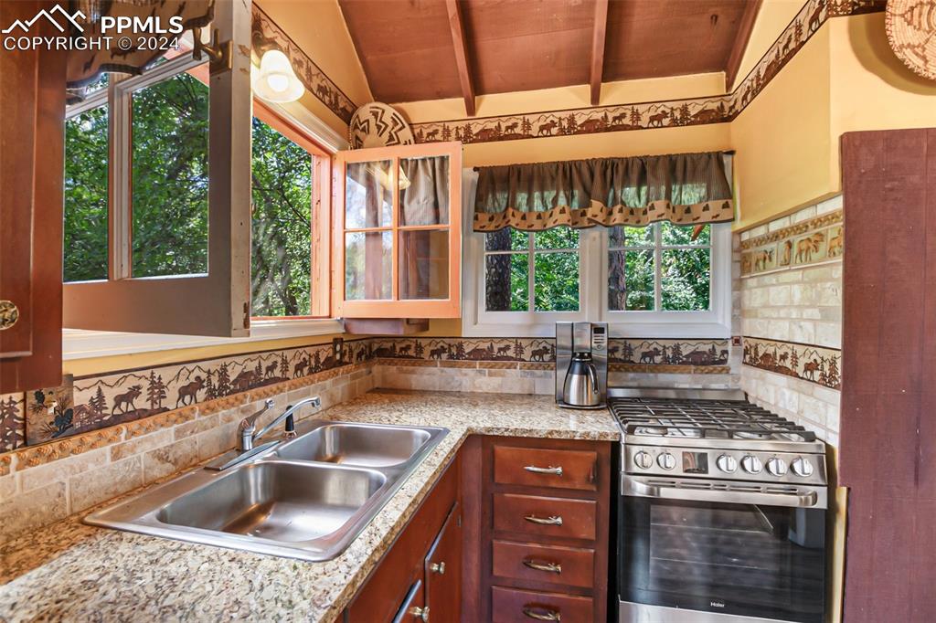 6015 Sioux Trail Cascade, CO 80809 - Photo 14 of 50 a kitchen with a stove a sink and a cabinets