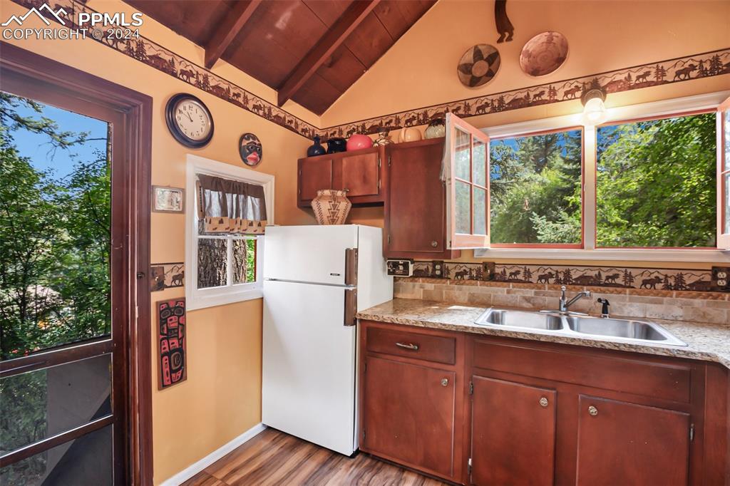 6015 Sioux Trail Cascade, CO 80809 - Photo 16 of 50 a kitchen with a refrigerator and a sink