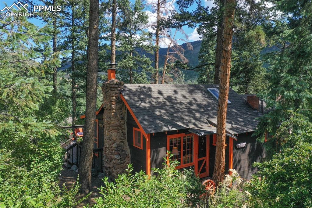 6015 Sioux Trail Cascade, CO 80809 - Photo 2 of 50 an aerial view of a house with a tree in front of it