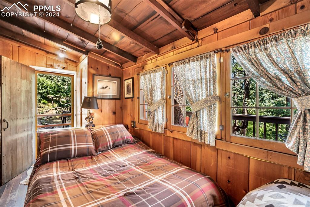 6015 Sioux Trail Cascade, CO 80809 - Photo 24 of 50 a bedroom with furniture and large windows