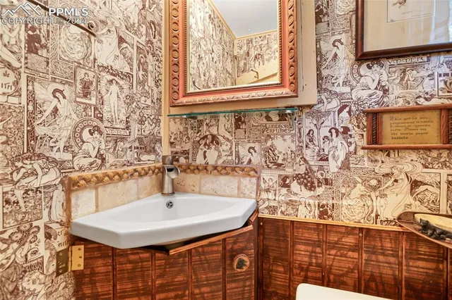 a bedroom with two beds and a lamp