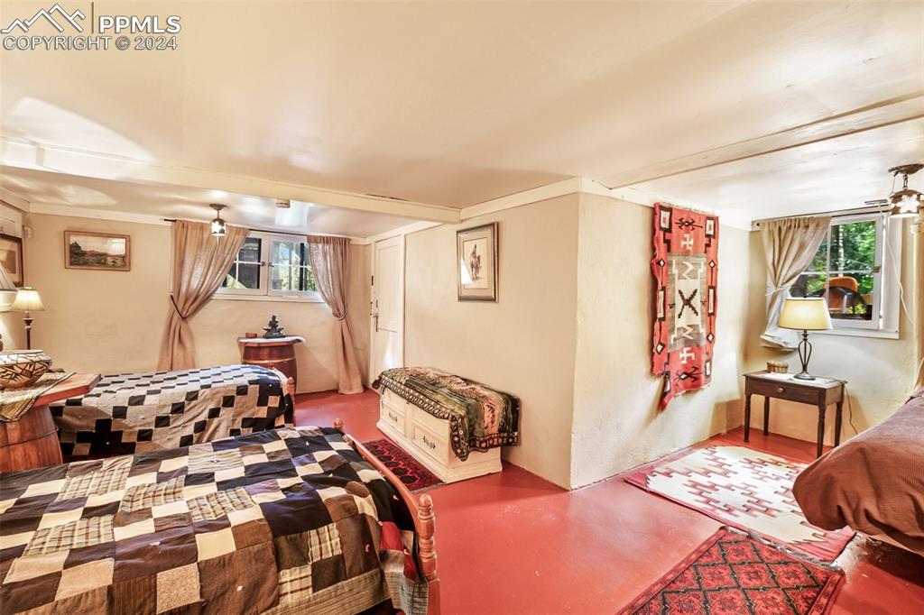 6015 Sioux Trail Cascade, CO 80809 - Photo 30 of 50 a bedroom with furniture and a wooden floor