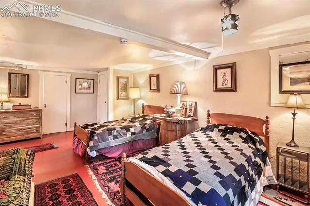 a bedroom with furniture and a lamp