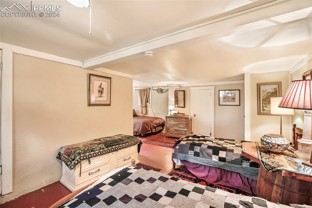 6015 Sioux Trail Cascade, CO 80809 - Photo 32 of 50 a bedroom with furniture and a lamp