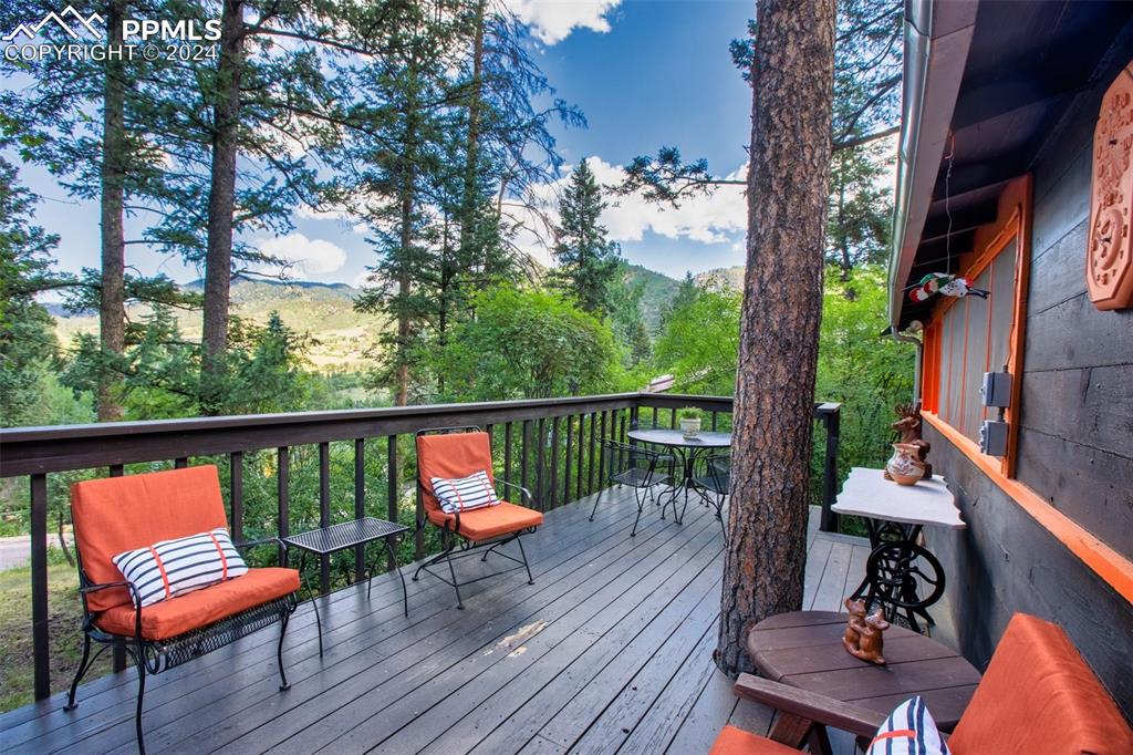 6015 Sioux Trail Cascade, CO 80809 - Photo 35 of 50 a balcony with wooden floor and outdoor seating