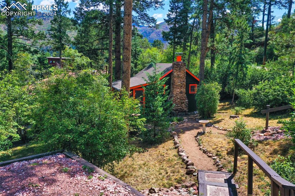 6015 Sioux Trail Cascade, CO 80809 - Photo 39 of 50 a view of house with wooden fence and garden