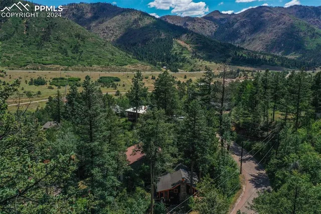 a wooden bench sitting in the middle of a backyard