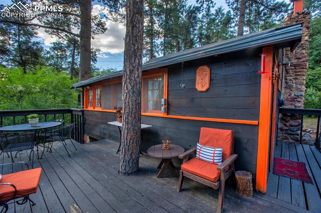 6015 Sioux Trail Cascade, CO 80809 - Photo 6 of 50 a backyard of a house with wooden floor outdoor seating and yard in the back
