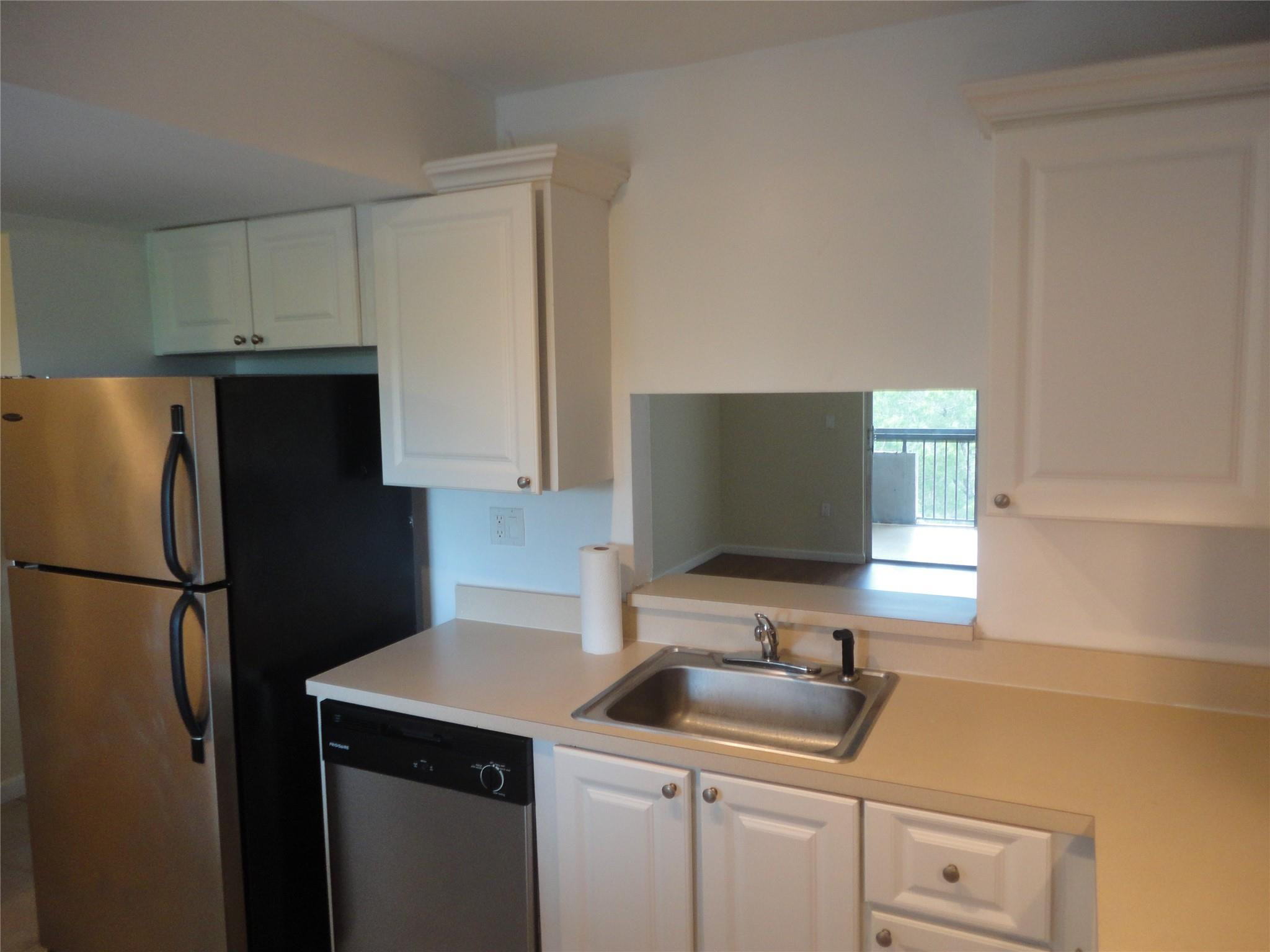 731 North Pine Island Road, Unit 402 Plantation, FL 33324 - Photo 2 of 11 a kitchen with a refrigerator and a sink