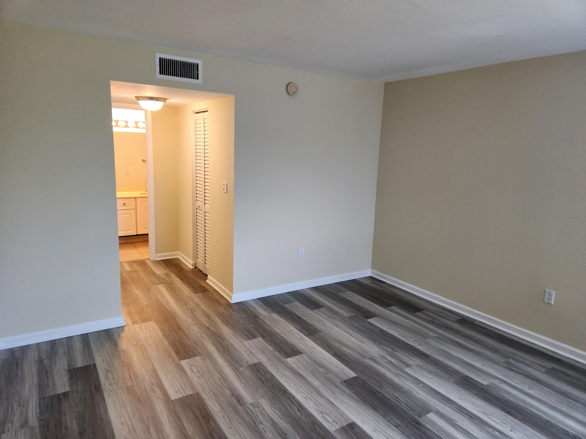 731 North Pine Island Road, Unit 402 Plantation, FL 33324 - Photo 6 of 11 a view of an empty room with wooden floor and a window