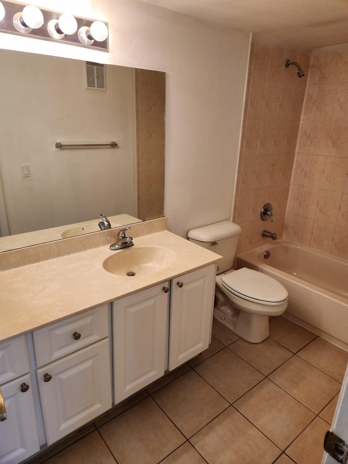 731 North Pine Island Road, Unit 402 Plantation, FL 33324 - Photo 9 of 11 a bathroom with a double vanity sink toilet and mirror
