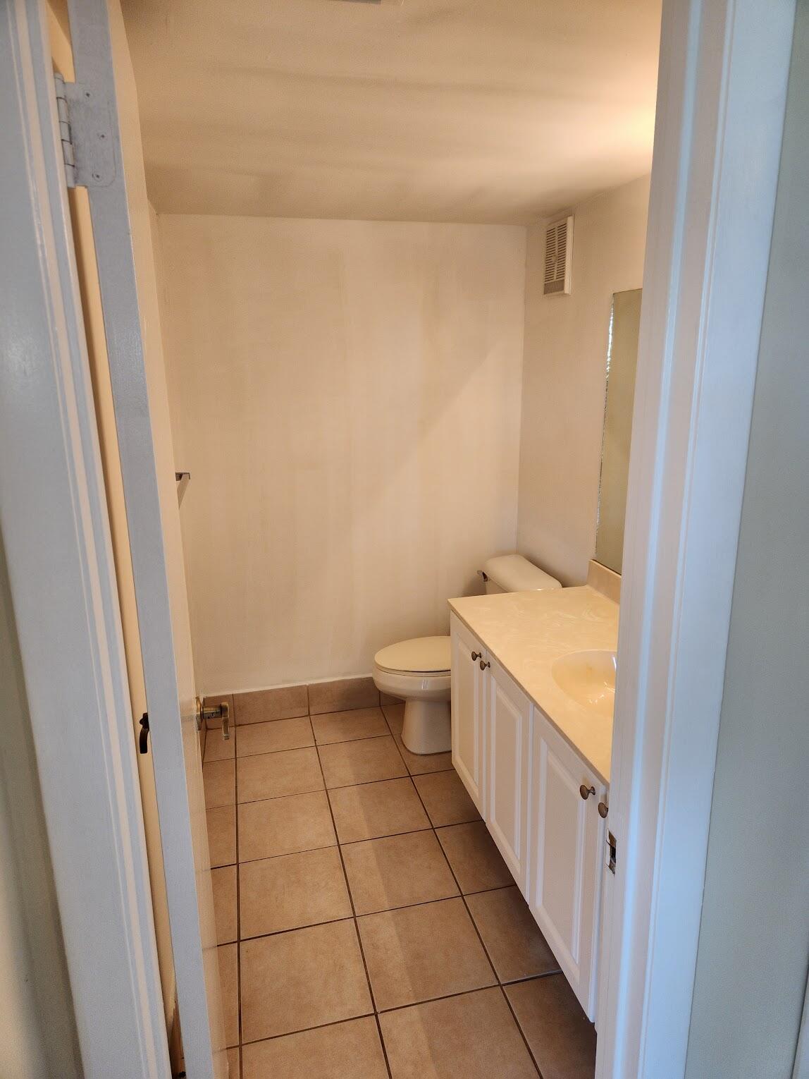 731 North Pine Island Road, Unit 402 Plantation, FL 33324 - Photo 10 of 11 a bathroom with a granite countertop sink and a toilet